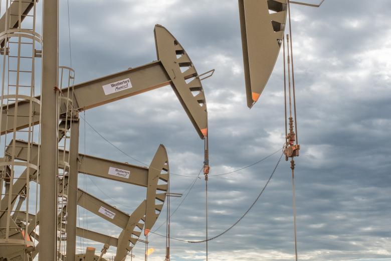 Photo of oil and gas drilling equipment under a cloudy sky