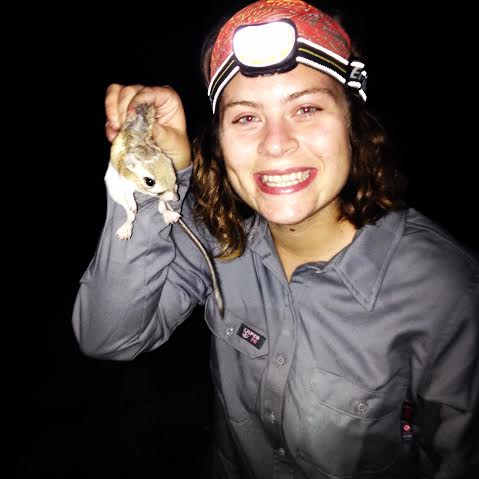 An intern holds a kangaroo rat.  BLM photo.