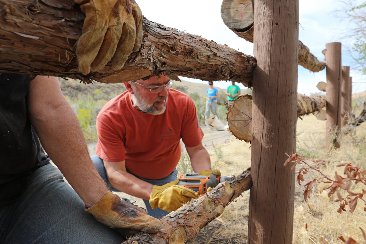 A volunteer builds a fence at a BLM Idaho National Public Lands Day event.