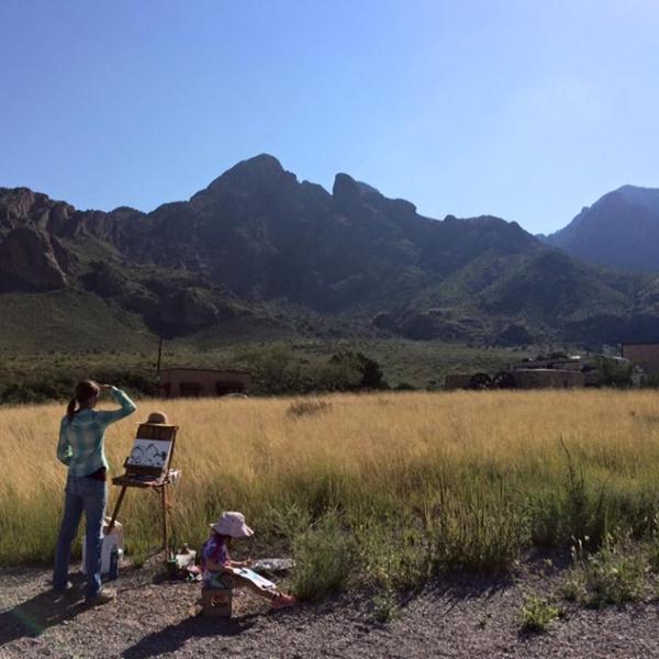 Along with a young budding artist, Meg Freyermuth paints the beautiful Organ Mountains as its first Artist-in-Residence. Photo by Daniella Barraza, Student Conservation Association Intern.