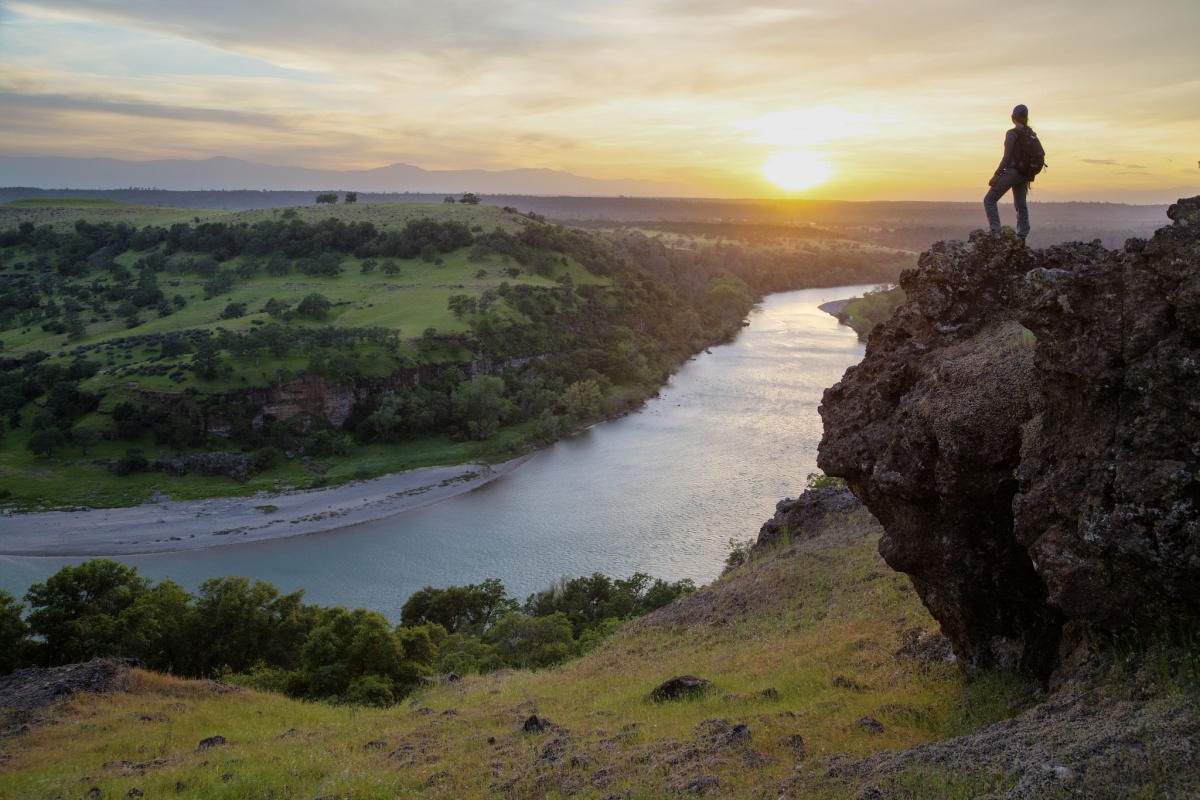 A women looks over the Sacramento River Bend Outstanding Natural Area in California at sunset, photo by Bob Wick, BLM  