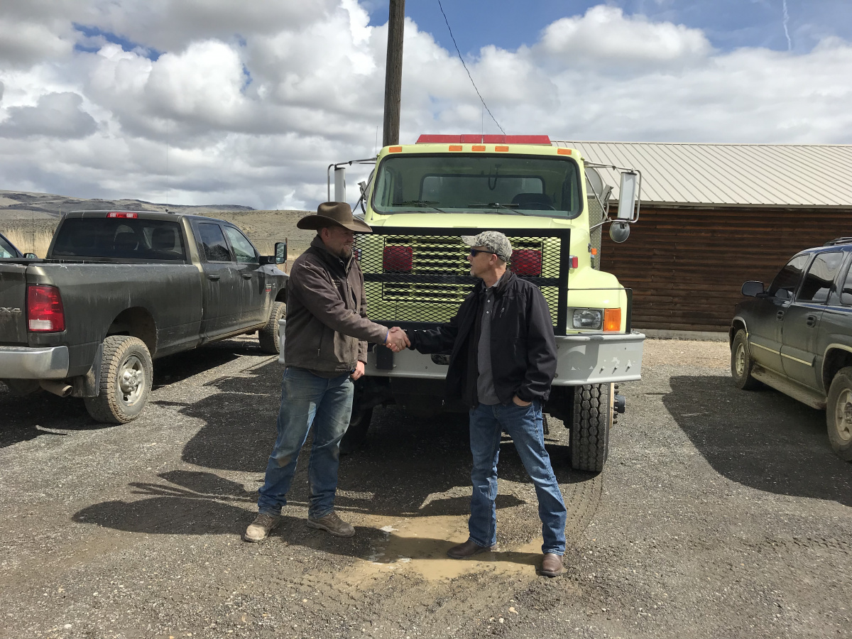 :  Boise BLM delivers wildland engine to the Owyhee Rangeland Fire Protection Association. On the left, Teo Maestrejuan, Owyhee RFPA Chairman. On the right, Russ Babiak, BLM Boise District Fire Management Officer.