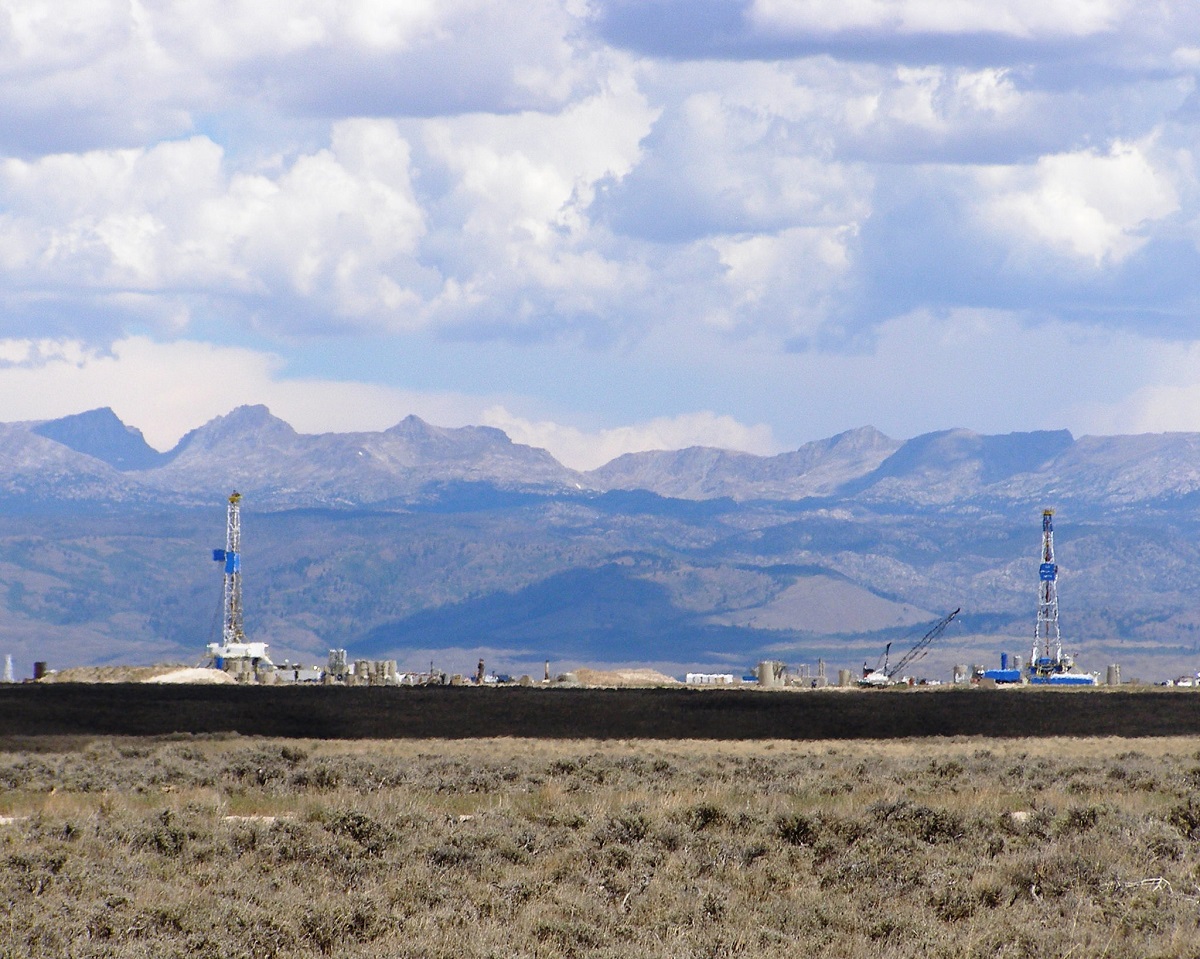 A landscape with oil and gas development in the distance