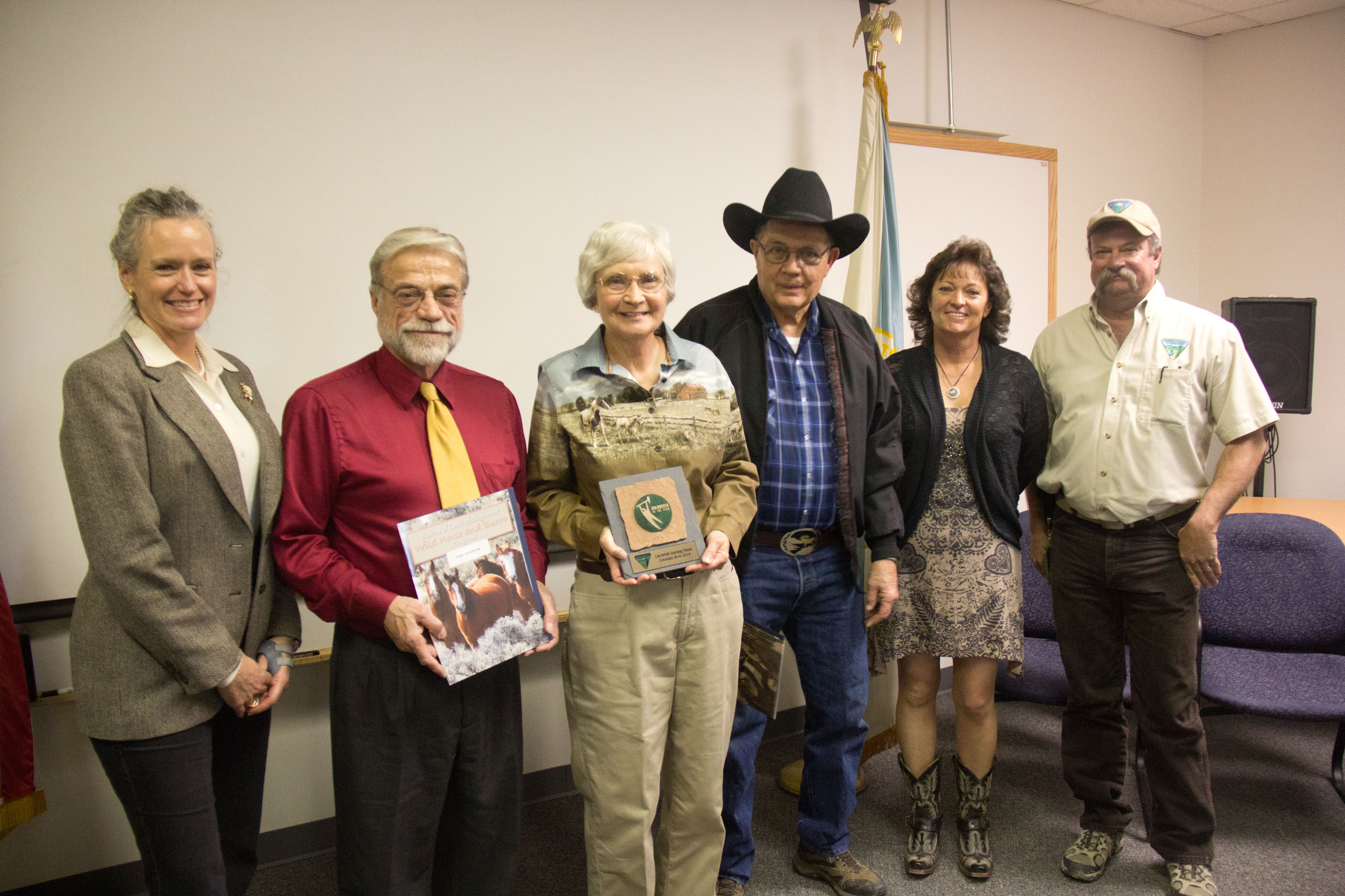 BLM Colorado State Director Ruth Welch awards members of the Little Book Cliffs Wild Horse Range Darting Team with the 2014 Volunteer of the Year Award.