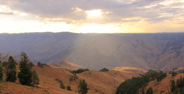 beam of sunlight breaks through the clouds onto Hells Canyon Wilderness Area