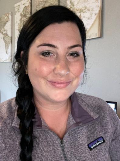 Woman with dark hair smiling.