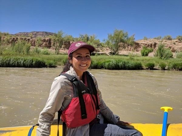 A woman canoeing on a river