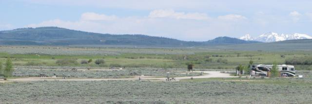 A campground surrounded by sagebrush and mountains