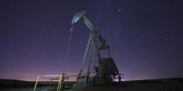 A pump jack at night in the Pecos District.