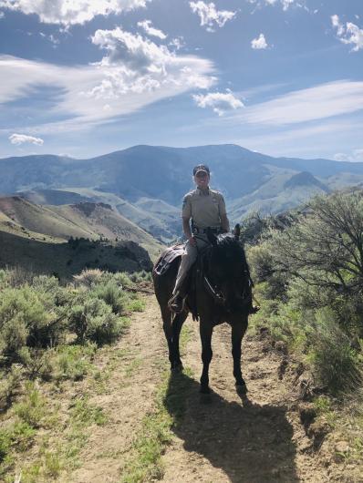 Special Agent in Charge Becky Andres patrolling BLM lands on Horse. Photo credit: BLM