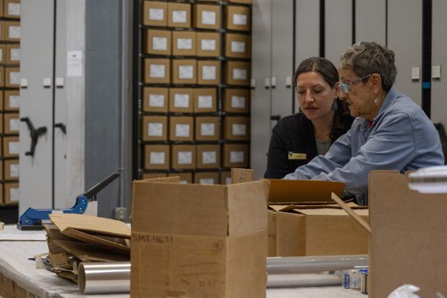 Blythe Morrison, a Museum Specialist at Canyons of the Ancients National Monument, and Marty Costos, a longtime volunteer at CANM, work together to repackage items in the CANM artifacts collection March 14, 2024, in Dolores, Colo. (BLM - Colorado photo by Brigette Waltermire).