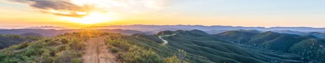 A dirt road on top of a mountain range.