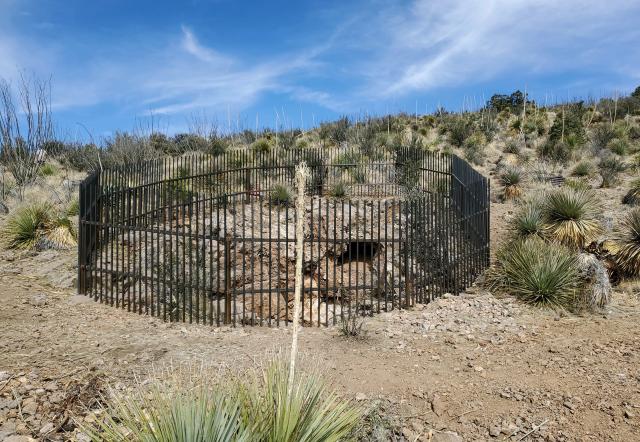 a fence around an old mine shaft