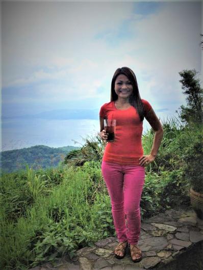 Jenifer Pable drinking Sago Gulaman and posing in front an active volcano in Tagaytay, Philippines.  Photo courtesy of Jennifer Pable.