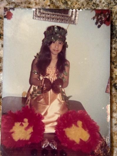 Tanya sitting in her handmade hula costume.  