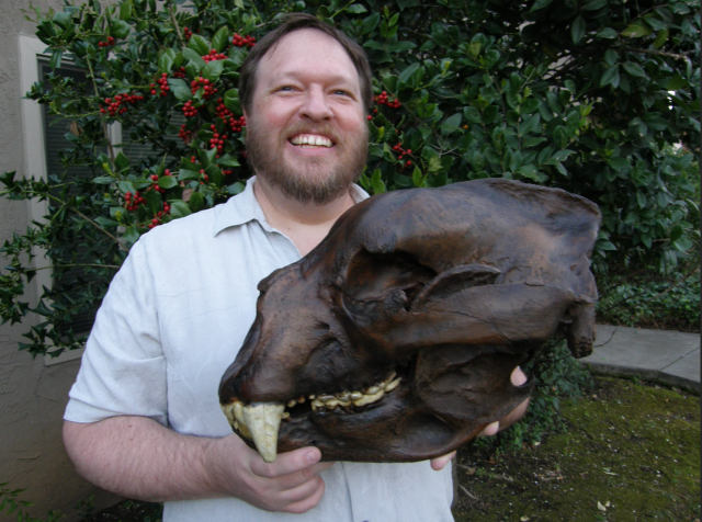 Greg holds a cast of a Short Faced Bear skull that was gifted to him in 2012 by the community board of the Gateway Science Museum in Chico, California.