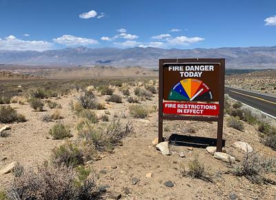 A sign in the desert indicating high fire danger