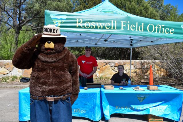 Smokey Bear himself stops by the Bureau of Land Management table during Smokey Bear Days in Capitan, N.M., May 3.