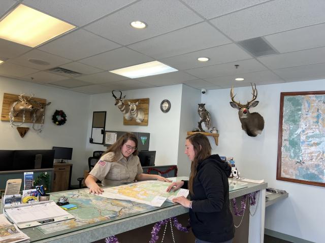 two women look over a map