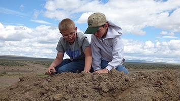 Two children playing in dirt