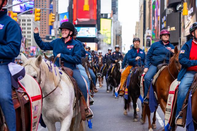 The photo shows two rows of horses and riders riding in New York City for the Trail to Zero veteran suicide awareness and prevention ride.