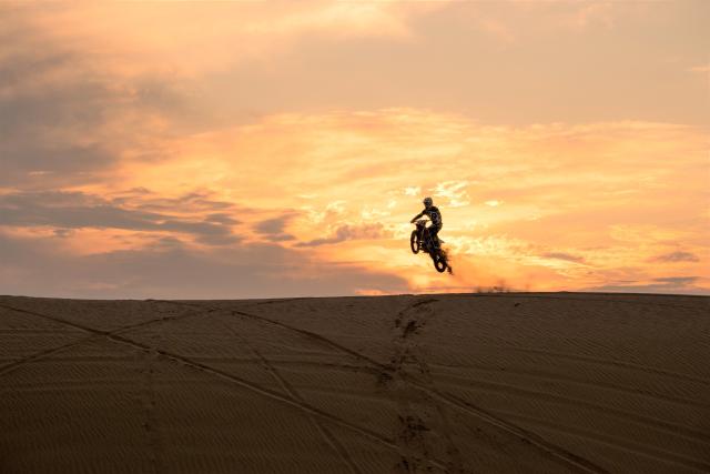 A motorcycle at sunrise in the Hackberry Lake off highway vehicle area.