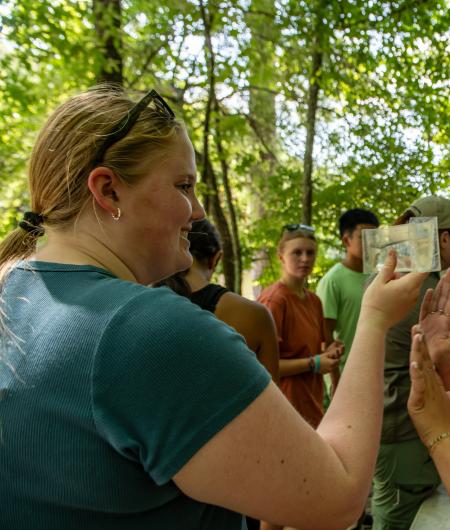 Daphne gets a close up look at a fish. BLM photo.