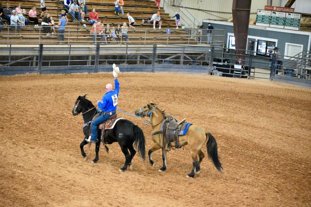 WHB Fest Day 2 - A man shows off his saddled horse. As he finishes the course, he throws up his cowboy hat to the crowd.