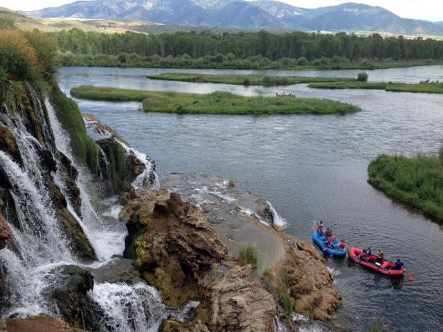 People recreating in two rafts (one blue and one red) at Fall Creek on the South Fork of the Snake River in Idaho