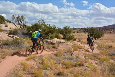 Mountain bikers on a desert, single track trail