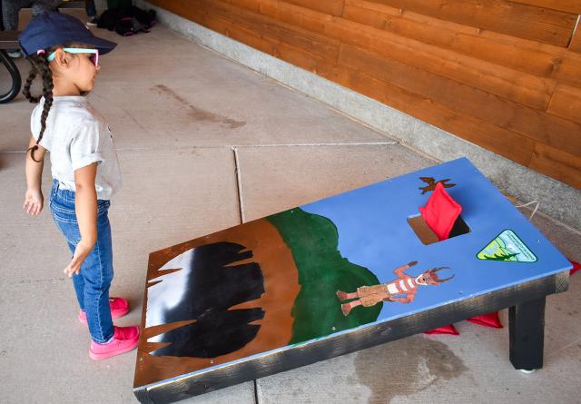 During lunch, a volunteer plays cornhole on a BLM-themed board that Warren Kasper, NCA manager, created.