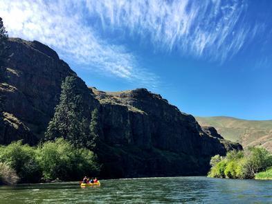 folks floating on the river on a sunny day