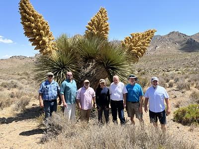 A row of people in front of desert flora