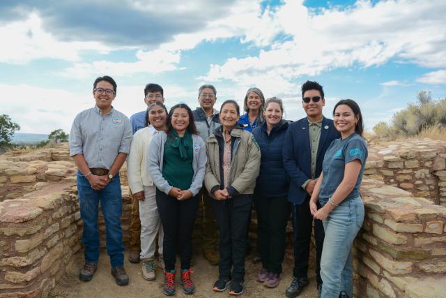 Ancestral Lands staff and interns pose for a photo with Secretary Deb Haaland at Escalante Pueblo.