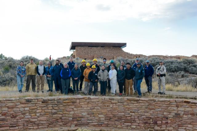 BLM staff and ALCC staff gather for a photo with Secretary Haaland at the great kiva.