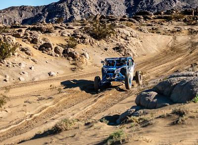 An off road vehicle in the desert.