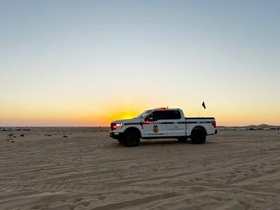 Ranger in the dunes at sunset