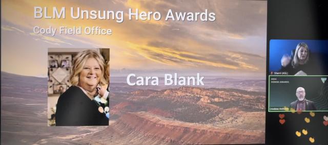 Computer screenshot includes a photo of a woman and the words "BLM Unsung Hero Awards Cody Field Office Cara Blank"; on the right side of the screen, a man is speaking, a woman is signing (ASL) and many clapping and heart emojis are visible.