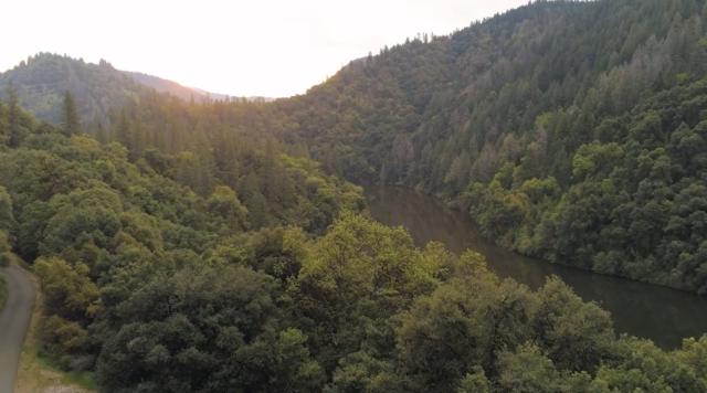 a sunset over a mountain and river