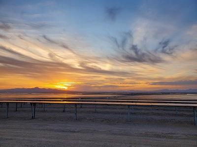 A solar array in the desert at sun rise