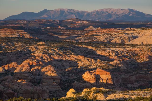 a sunset over a vast, rocky canyon