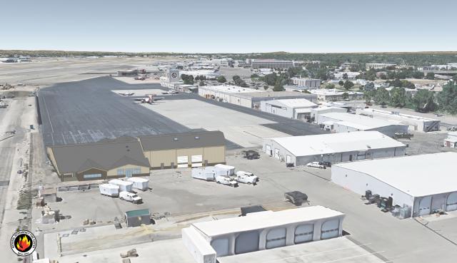 Aerial view of tarmac, planes, and buildings. 