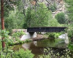 A bridge over a water filled creek. 