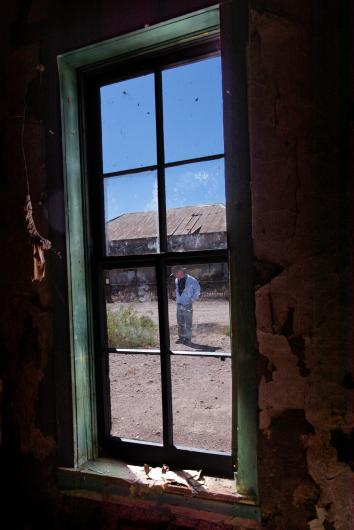 A man on the other side of a pane of glass.