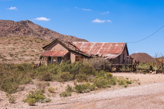 An old house along a dirt road.