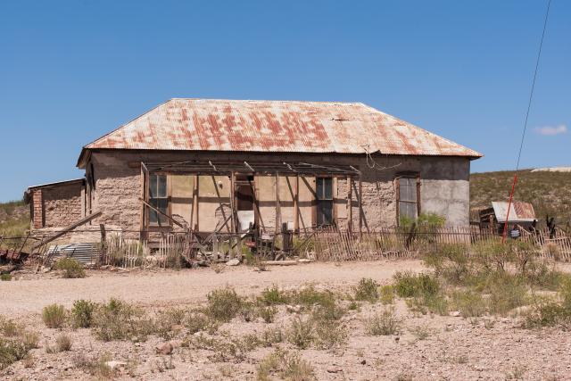 An old house along a dirt road.