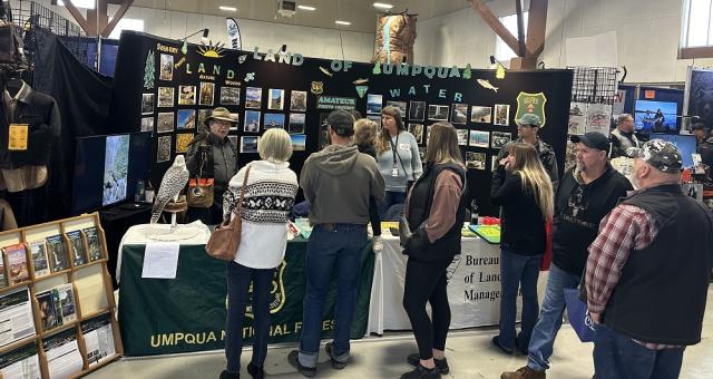 group of people standing near a table display