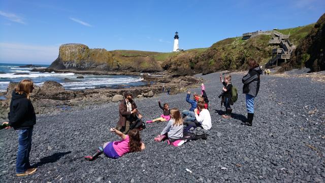 ranger teaching a group of children and teachers on Cobble Beach