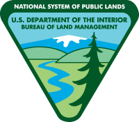 The BLM Official Logo displaying an inverted triangle with a pine tree, snow capped mountain, a river an hills.