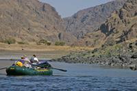 Photo of two BLM employees in a raft conducting a patrol of the Lower Salmon River in Idaho.